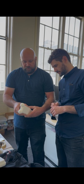 Devin showing the 3D printed frame for Fawn's robot